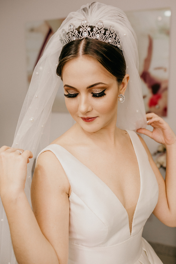 Charming bride in wedding dress with makeup in bijouterie