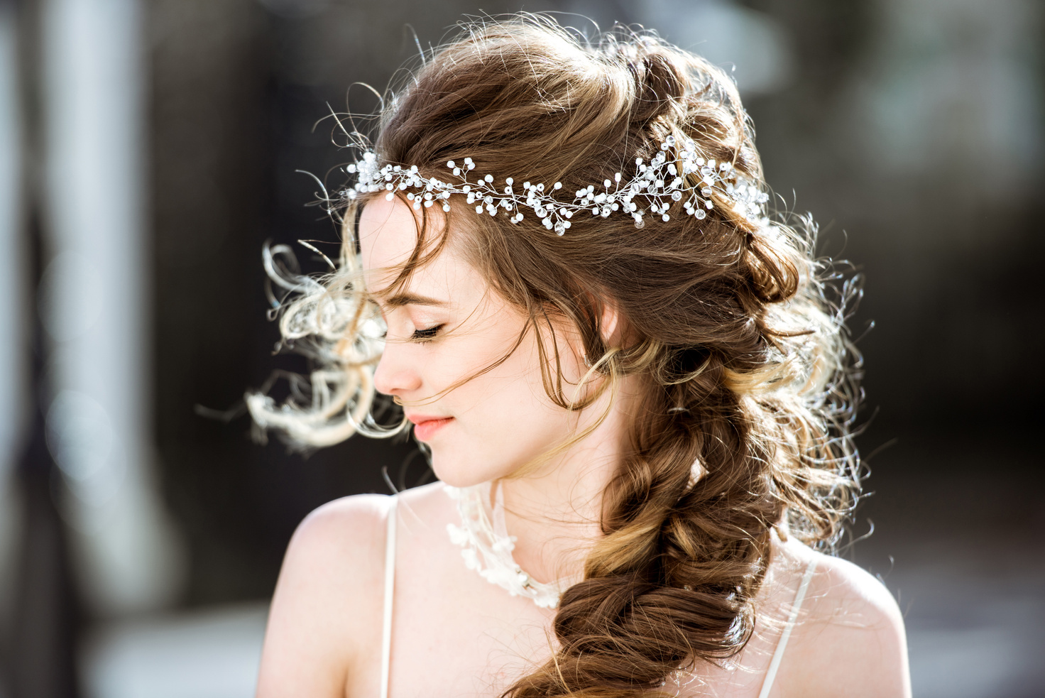 Closeup brunette bride with fashion wedding hairstyle and makeup